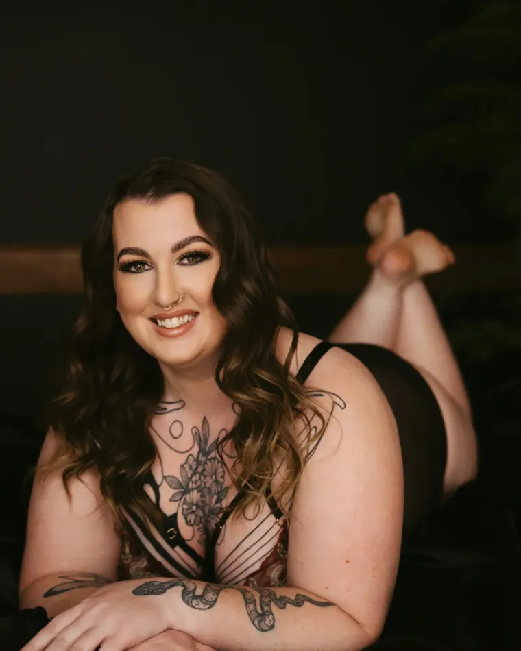 Boudoir portrait of a smiling woman in black lingerie